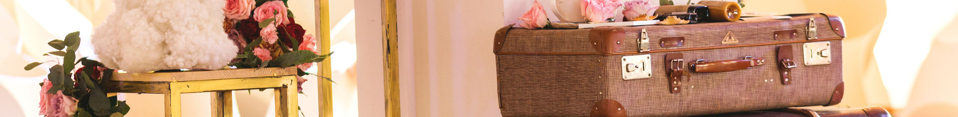 Stack of Vintage Suitcases with flowers at a wedding