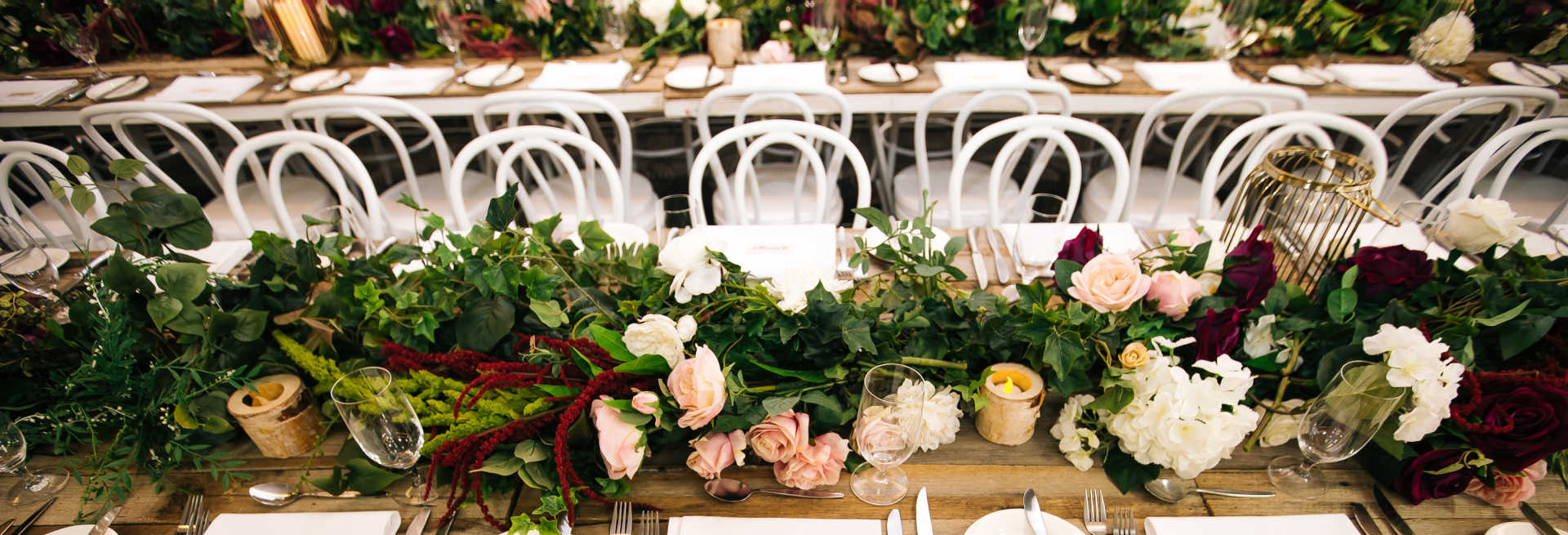 Rustic wedding table setup with flower garlands